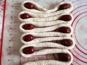 5.	将搓好的长条摆成回形状，在每个转弯处放一颗大枣，第一层一共放10颗大枣，