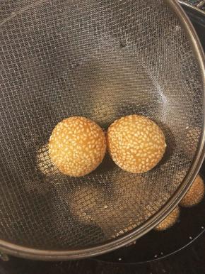 等到炸到麻团表面都变成金黄色就可以了，用漏勺捞出控干油即可装到盘子里。麻团趁热吃外酥内软，特别好吃。