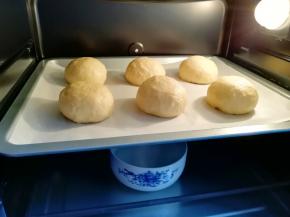 烤箱调至“发酵”功能，放入一碗热水，将面包生胚送入烤箱二次发酵。