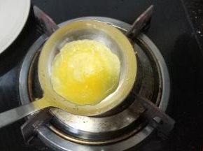 转动大铁勺，让蛋液平铺