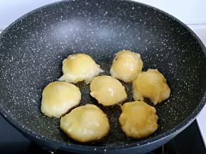 起油锅，加入粘豆包，小火煎。