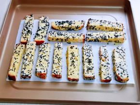 依次做完的吐司条，摆放垫油纸的烤盘中，并间隔距离。