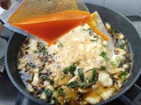 再撒入一点葱花，配的辣油也一起下入锅内。