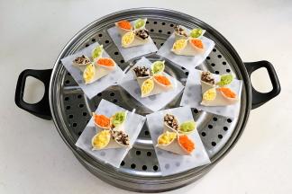 包好的饺子依次摆入蒸屉上，记得要垫油纸或蒸布。