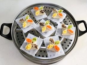 包好的饺子依次摆入蒸屉上，记得要垫油纸或蒸布。