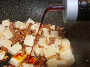 豆腐放进去、调入少许生抽用锅铲翻拌均匀。