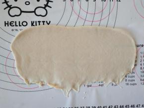 取面团擀成椭圆形，翻面，压薄底边。