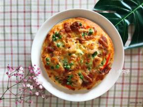 烤箱温度调整为200度，提前预热，将披萨放入烤盘中层，烤15分钟取出即可