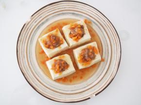 蒸好的豆腐倒掉汤汁盛盘备用。将胡萝卜切碎，锅中加适量清水和淀粉，加入胡萝卜碎勾成芡，浇在豆腐上