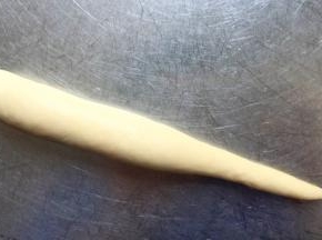 从一边卷起，卷成一头粗一头洗的条