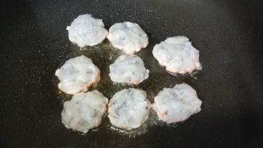 手湿水，将虾泥捏成圆饼形，放入不粘锅里