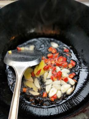 锅子烧热放油加入大蒜辣椒姜片爆炒一下