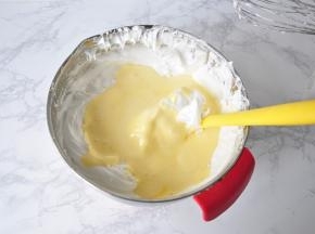 然后再把面糊倒入蛋白霜盆中，用同样的手法拌均匀。