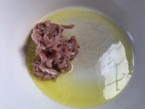 锅烧热油至六成热，下入腌制好的瘦肉丝，炒断生