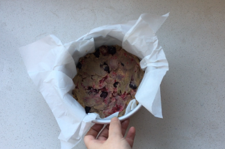 6寸戚风模具中放置一张油纸，边缘无需完全贴合，将面糊倒入到模具中，大致抹平