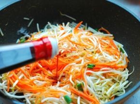 翻炒一会儿，等绿豆芽和胡萝卜丝稍微有些变软的时候，加入2勺生抽、1勺蚝油。翻炒均匀。