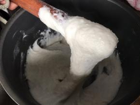 把煮好的糯米饭用擀面杖捶打成无颗粒状