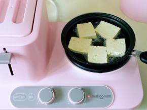 煎锅中加入食用油，再把切好的豆腐依次摆放到锅中。