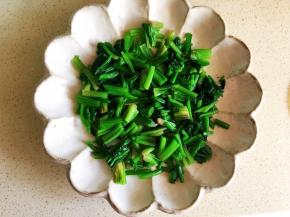 选一个有深度的器皿，将菠菜段码放在底部。