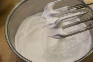 将蛋清冷冻至表面一层薄冰，取出滴入5滴柠檬汁，分三次将细砂糖加入蛋清内，打发至干性发泡（短而小的尖角）。