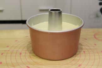 倒入七寸日式梯形加高活底蛋糕模内，从离桌面3公分的地方轻轻震一下去气泡。