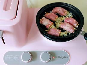 煎盘中刷上少许食用油，将培根金针菇卷摆放好，煎至2分钟。