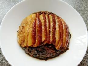 取出天津扣肉，将多余的汤汁滗出来倒回锅中再次浓缩，用水淀粉勾芡，把天津扣肉的碗上面盖上一个盘子，迅速将盘子翻个面，梅菜扣肉就反扣在了盘中。