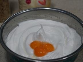 然后再分次将蛋黄加至蛋白糊里，提高打蛋器的转速，将蛋黄均匀混合至蛋白糊里。