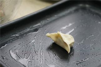 多用锅的煎盘刷一层薄油，将包好的饺子码放在上面。