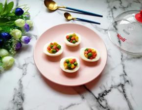 将炒好的豌豆、玉米粒和火腿肠盛入蛋白里面。