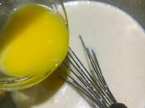 黄油隔热水融化开倒入面糊搅拌均匀。