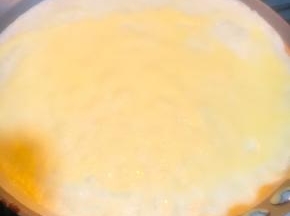 小火热锅后倒入一勺面糊左右摇摆煎锅摊至均匀，面糊约80克，小火煎至表面鼓出小泡即可离火，直接向盘内倒扣煎锅，轻微晃动即可自动脱落。