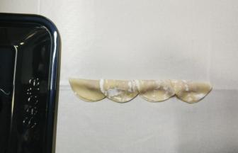 3.抹好馅料后把饺子皮对半折好
