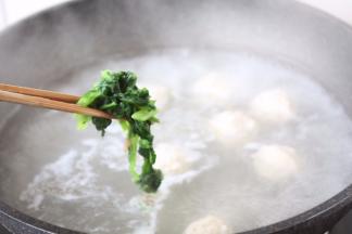 将菠菜放入鸡肉丸子汤里。
