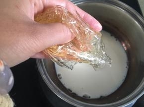 牛奶小火加热至边缘冒泡，把泡软的吉利丁片挤干水分放入牛奶中，搅拌均匀至融化。