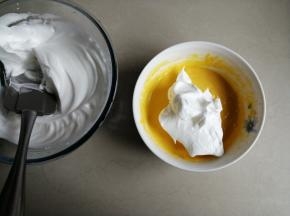 取1/3打发好的蛋白霜到蛋黄糊里，从底部向上翻拌并切拌均匀