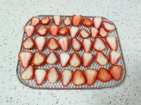 淡盐水泡过的草莓清洗干净，用厨房用纸吸干水分，一切两半摆在烤网上。