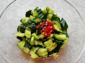 将腌制好的小米椒带汁一起浇在黄瓜上，搅拌均匀。