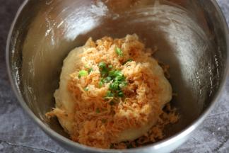 撒上芝士、肉松、小葱将面团混合成团。