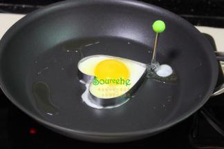 把蛋黄倒入固定的蛋白上，继续小火煎至蛋黄半凝固状态，加少许冷水，蛋黄造型美观，颜色亮丽又鲜嫩。