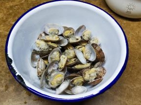 将煮好的花蛤沥干水分放入碗里