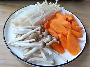 胡萝卜削皮切滚刀块、秀珍菇与金针菇掰开洗干净。