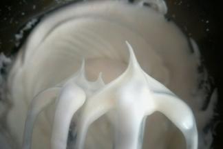 加入最后三分之一的糖，继续低速打发至打蛋器提起，蛋白呈小弯尖状态即可