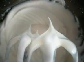 加入最后三分之一的糖，继续低速打发至打蛋器提起，蛋白呈小弯尖状态即可