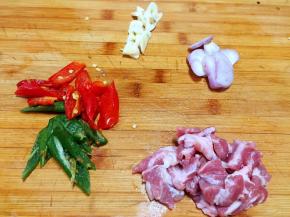 猪梅花肉切片，辣椒切滚刀块，毛葱大蒜切片