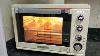 预热烤箱，上下火180度。
轻压面团表面，能缓慢回弹就代表二发好了。烤箱预热好后，把汉堡胚放烤箱中层，烤18–20分，上色及时加盖锡纸。温度和时间根据自己的烤箱来调整。