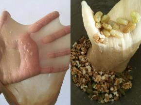 继续搅拌至可以拉出手套膜的状态，加入泡好的葡萄干和核桃仁低速拌匀。