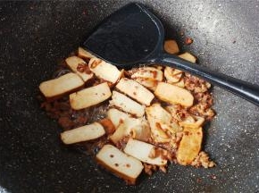 香干洗净切条，倒入锅中跟肉末一起翻炒，撒入少许盐调味。