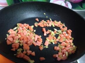 锅烧热加油倒入榨菜丁和火腿丁炒出香味