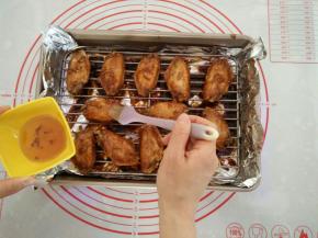 再次取出鸡翅，两面刷上蜂蜜。两面继续各烤2分钟，有热风功能的此时可以开启。